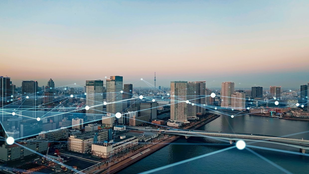City skyline overlaid with a connected network graphic