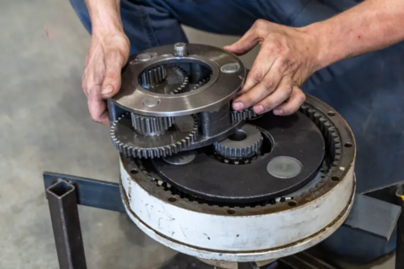 Technician aligns gears during a clutch winter service on a heavy-duty transmission assembly.
