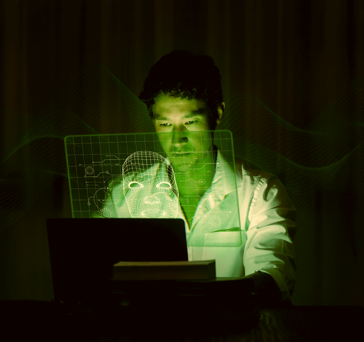 Person sitting in the dark in front of a screen, green lit