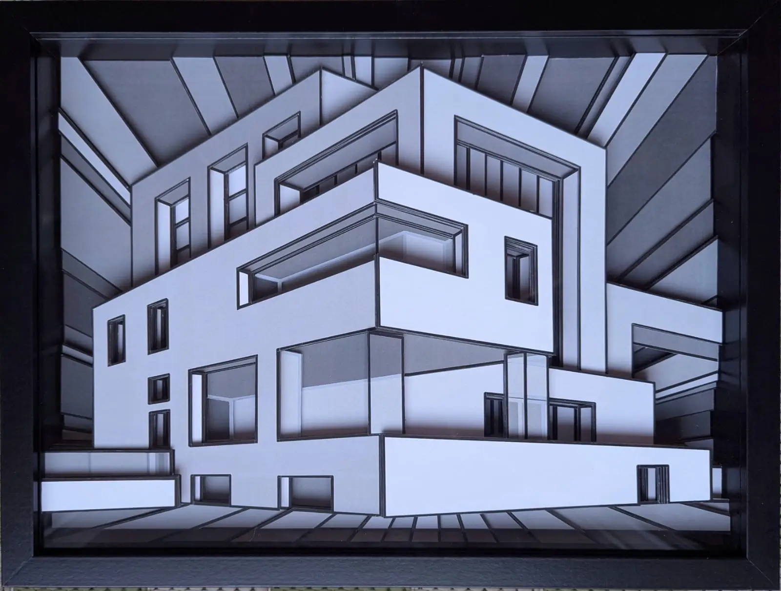 Relief géométrique monochrome en niveaux de gris, volumes architecturaux imbriqués créant une structure urbaine stylisée.