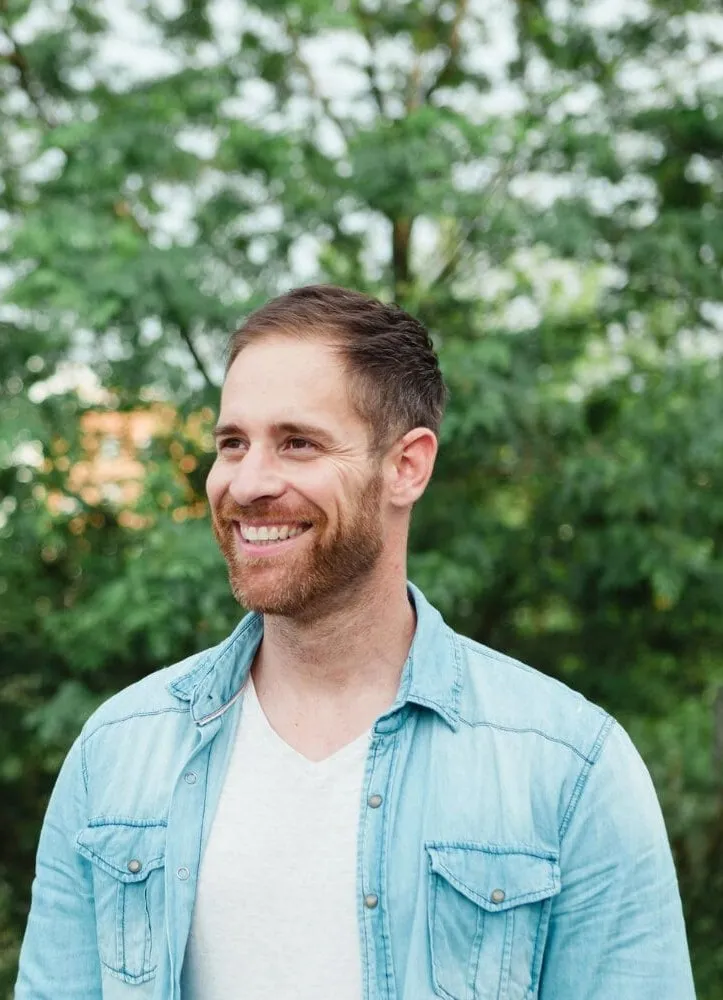 man smiling wearing blue shirt