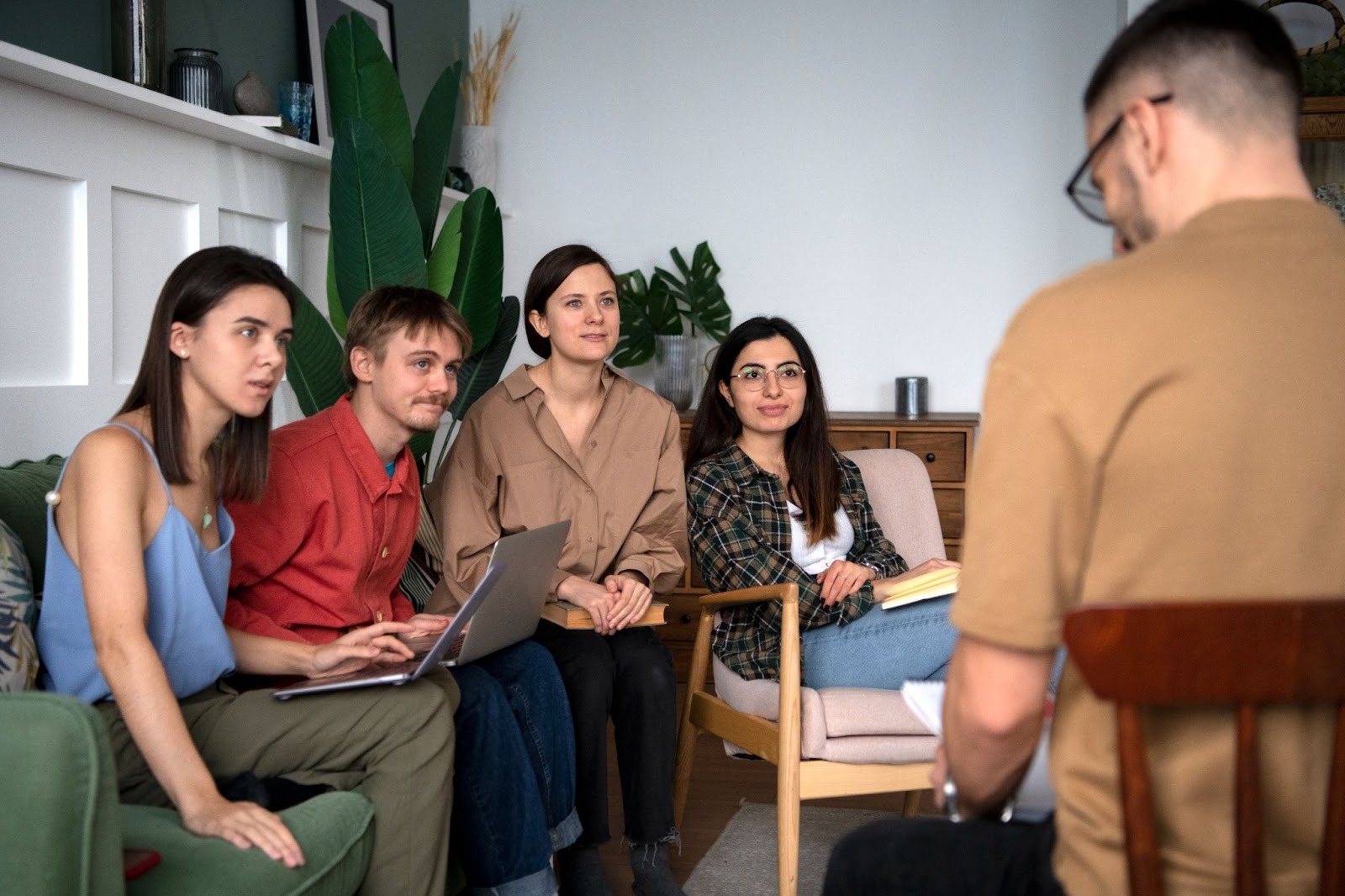 A group of five people discussing an addiction treatment center covered by OHP