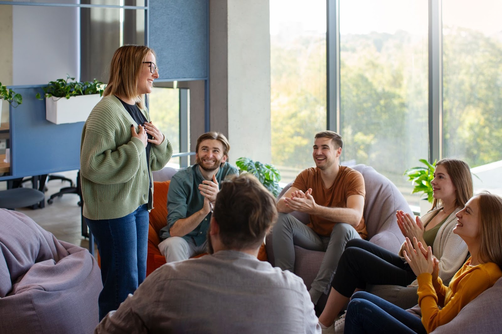 A woman leads a supportive group discussion, highlighting the encouragement and guidance available through DUII programs in Oregon