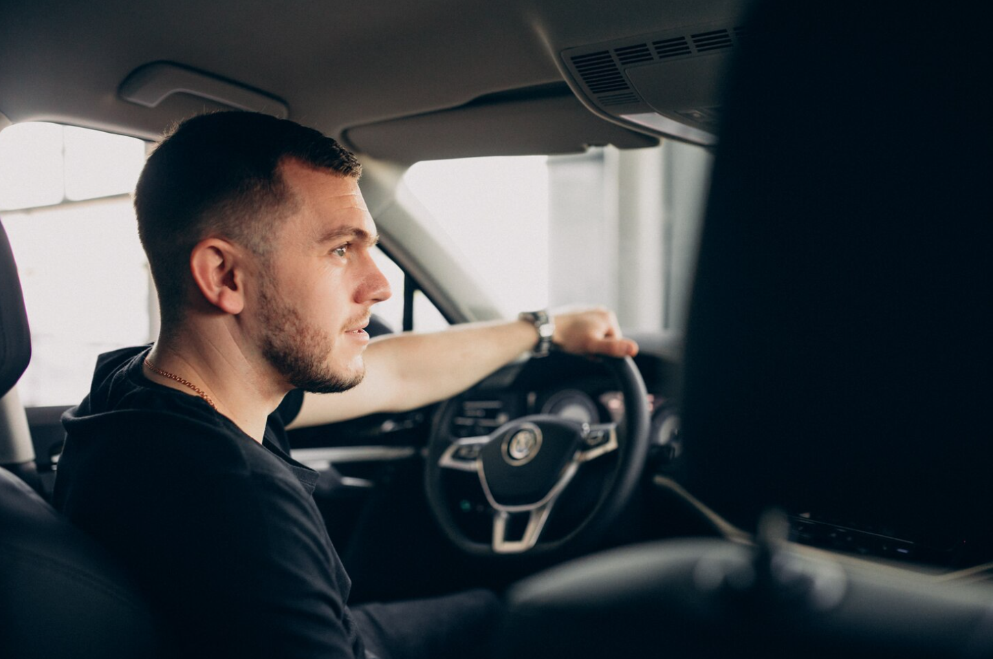 A man sits behind the wheel, highlighting the importance of alertness, safe driving, and the avoidance of substance use
