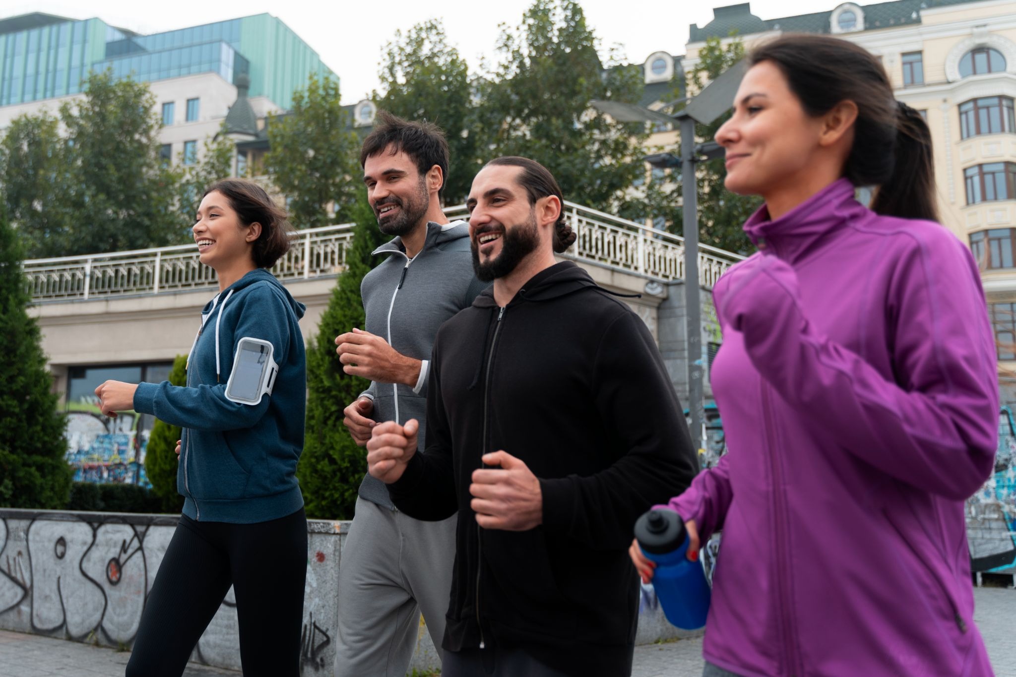  A group of people jogging outdoors together, representing healthy lifestyle habits and support during addiction recovery