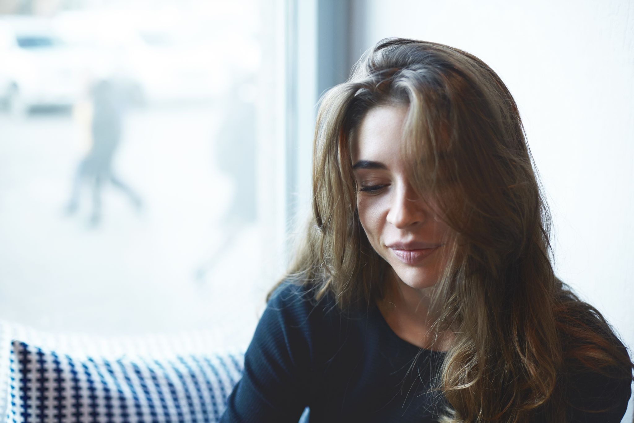 Young woman reflecting indoors, representing emotional healing and mental health support during stimulant recovery