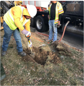 Our crew digging a hole in the dirt.