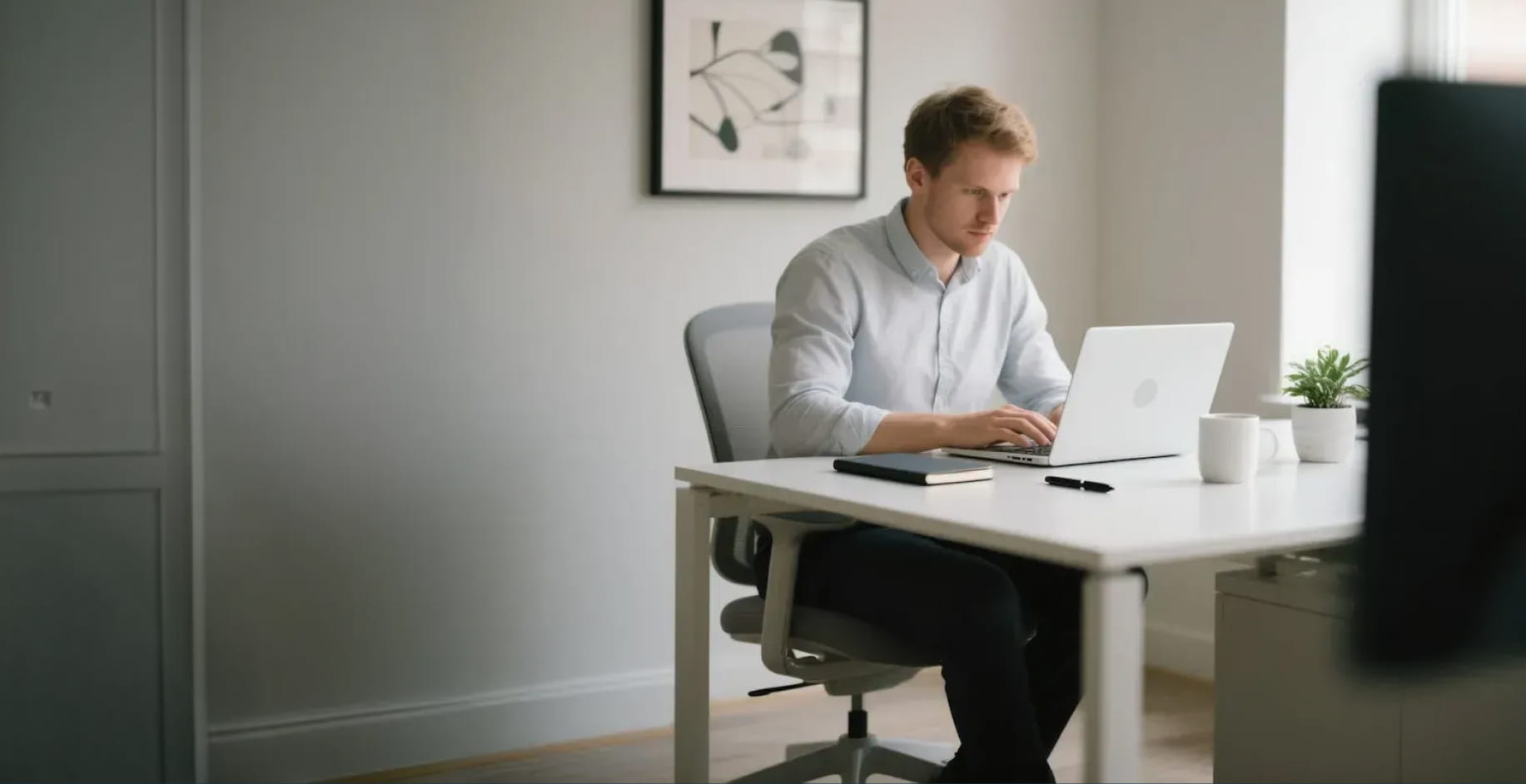Entrepreneur working at a desk with laptop, illustrating how small businesses can improve visibility through SEO and generative engine optimization