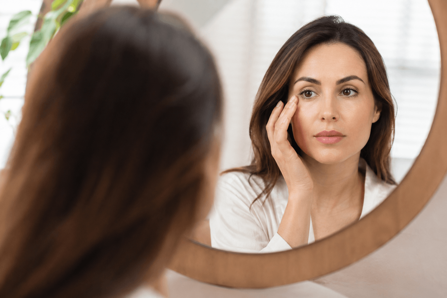 Patient evaluating droopy eyelids for eyelid surgery candidacy in Houston Texas
