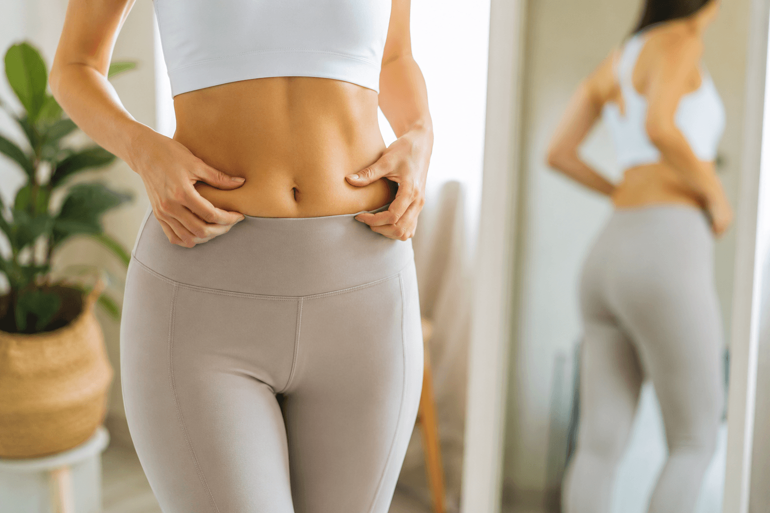 Patient exploring non-surgical tummy tuck options in Houston Texas for abdominal tightening and fat reduction