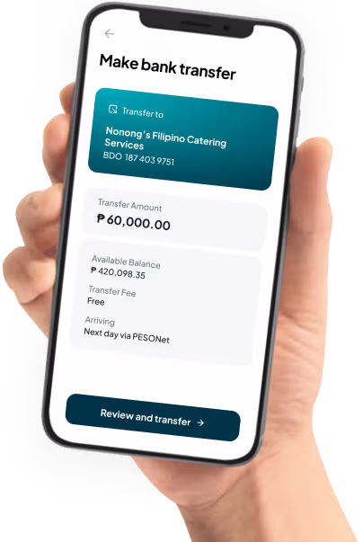 Hand holding phone showing bank transfer to Nonong's Filipino Catering Services for ₱60,000, free fee, next day arrival.