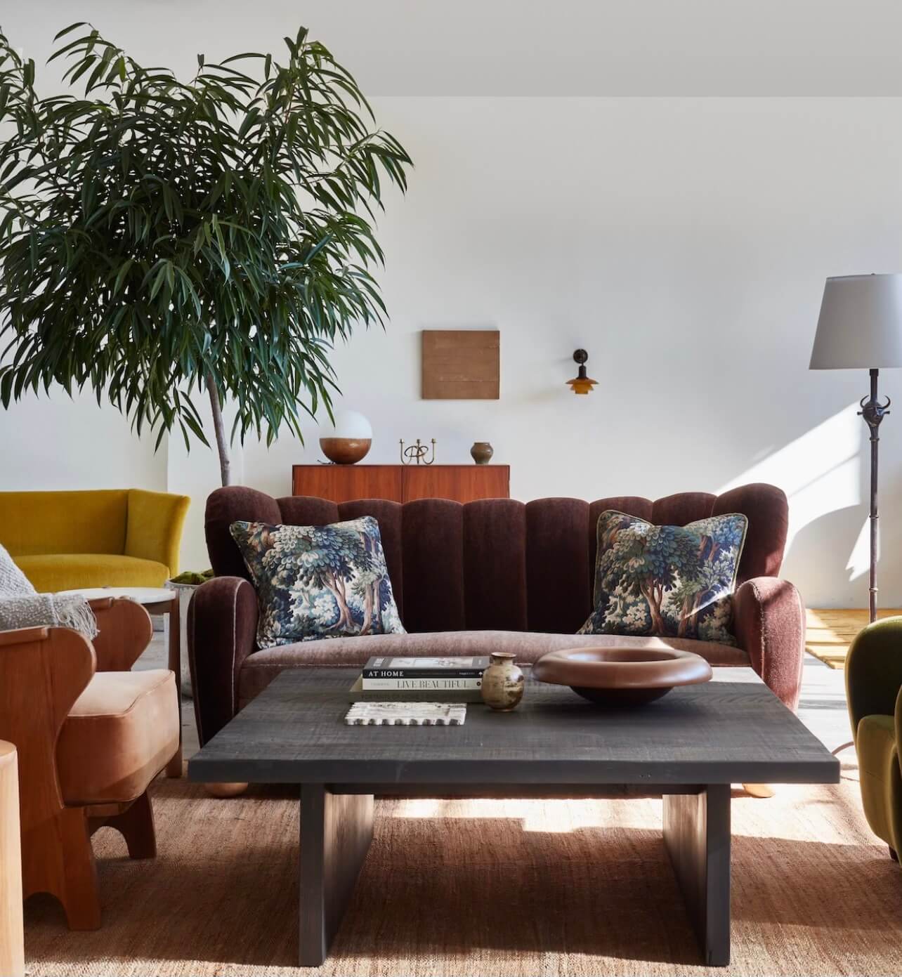 A a living room with a couch, chair, table and a plant
