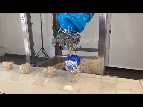 Chef robot deposits chicken salad