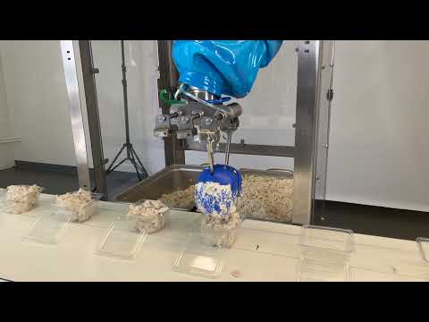 Chef robot deposits chicken salad
