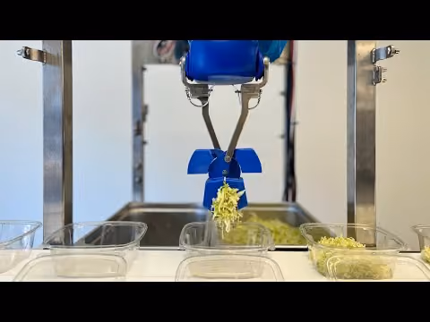 Chef robot assembling salad with chicken and corn