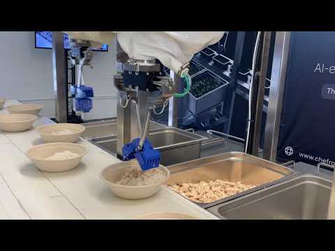 Chef robot depositing chicken and rice