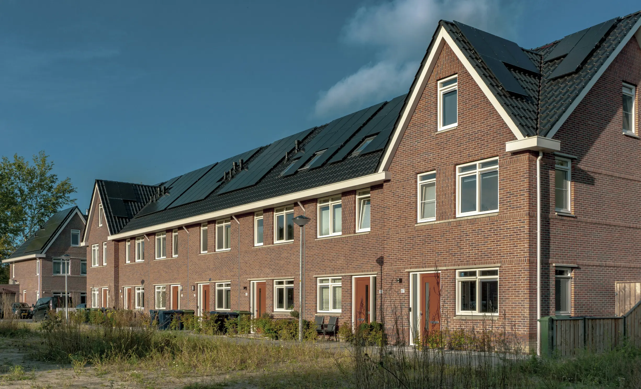 Een woning met allerlei duurzame toevoegingen zoals zonnepanelen en laadpalen.