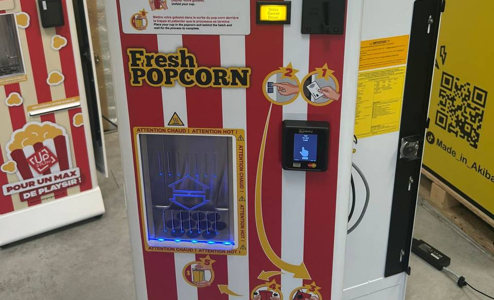 Colourful gumball vending machine filled with multi-coloured candy