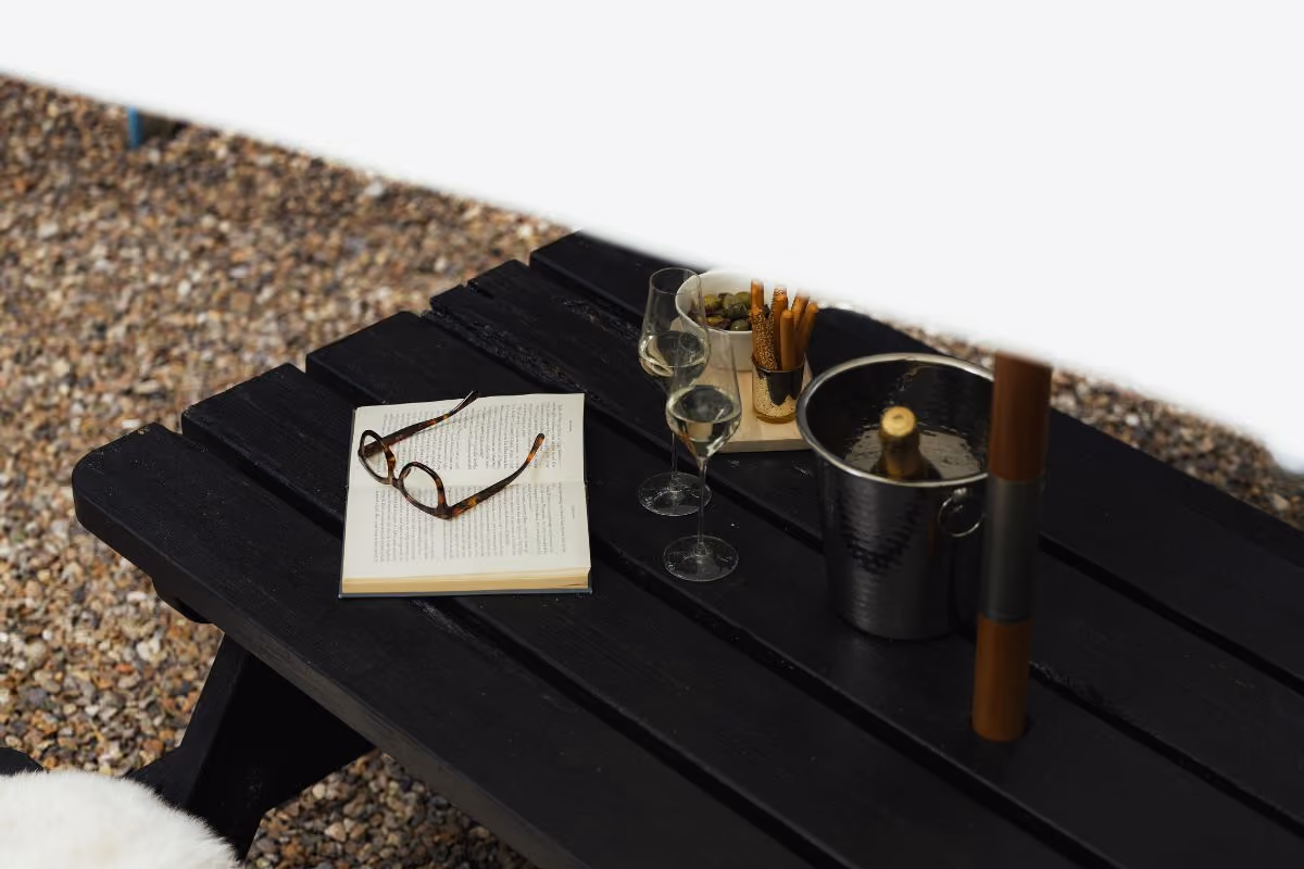 Picnic bench and umbrella at the Camping Pod terrace
