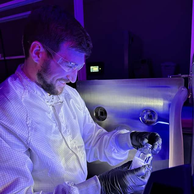 LyoWave engineer handling a sample vial at a freeze dryer