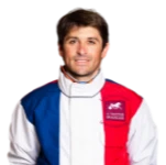 A man wearing a red, white, and blue jacket.