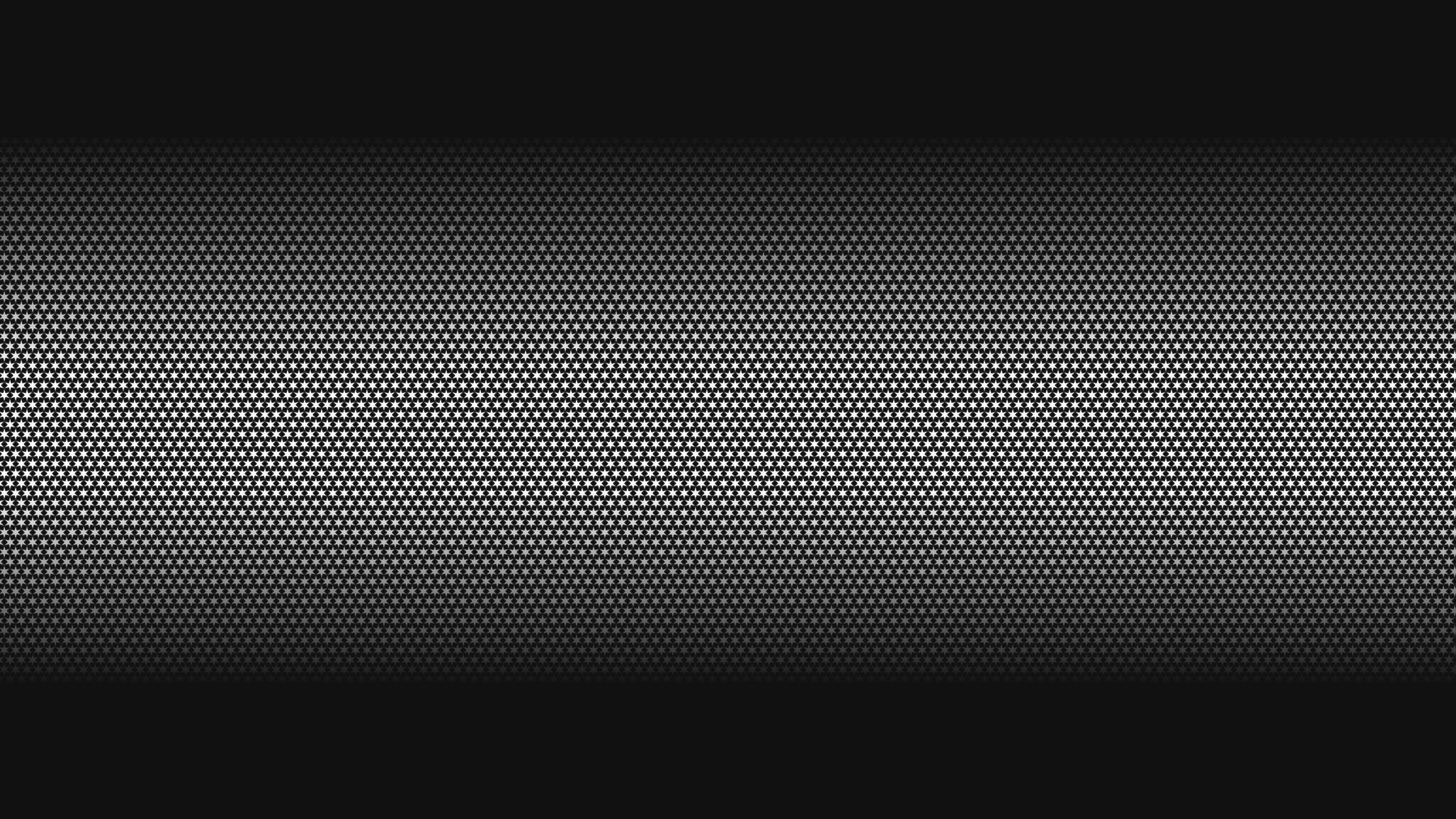 A black and white photo of a clock on a wall.