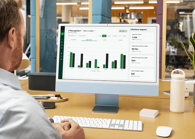 A man in his office reviewing the individual container MyMatR dashboard