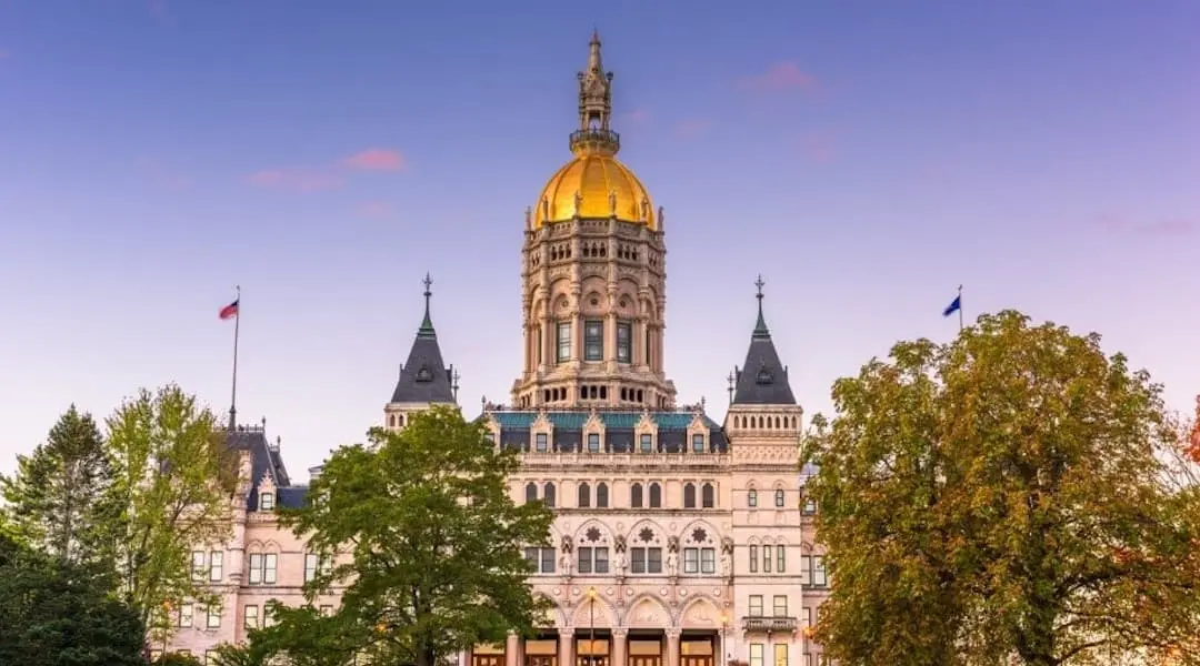 Hartford, Connecticut cityscape featuring the Connecticut State Capitol with its iconic gold dome and historic government building.