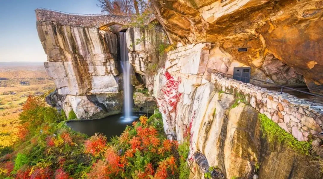 Georgia landscape featuring a scenic waterfall, cliffside overlook, and fall foliage, highlighting the state’s natural beauty.