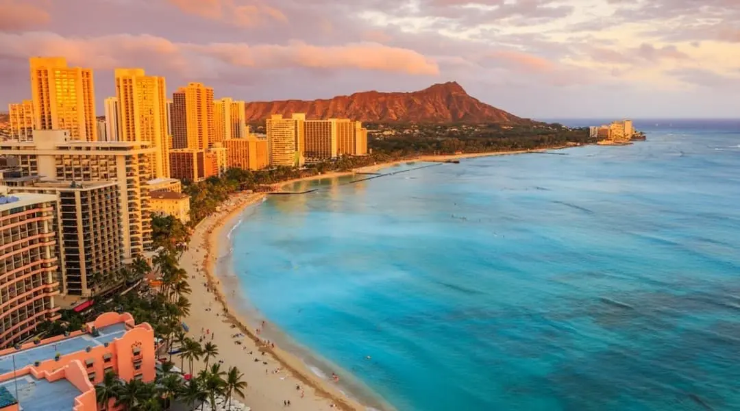 Hawaii coastal cityscape featuring Waikiki Beach, Honolulu high-rises, and Diamond Head overlooking the Pacific Ocean.