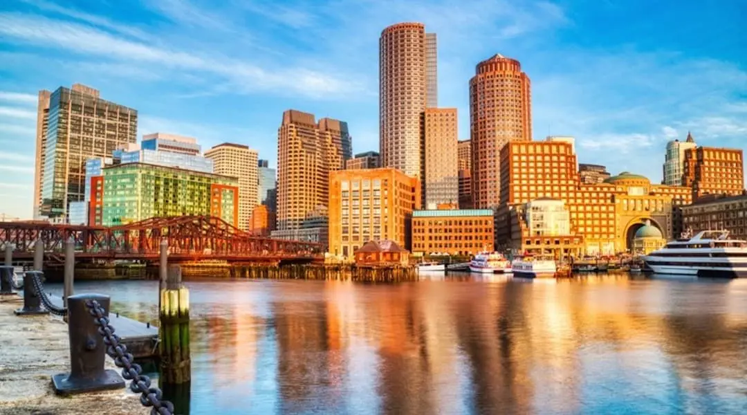 Massachusetts cityscape showing the Boston waterfront skyline with downtown buildings and harbor views.