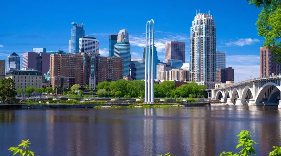 Minnesota cityscape showing the Minneapolis skyline and Mississippi River, highlighting the state’s urban riverfront landscape.