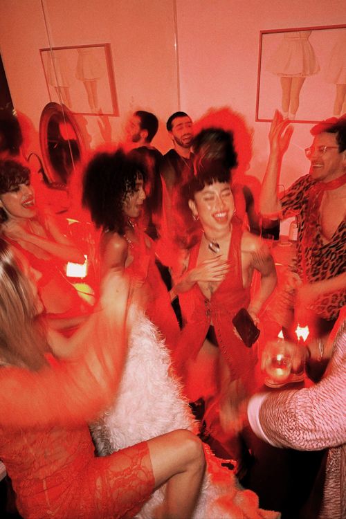 Smiling people at a red themed party