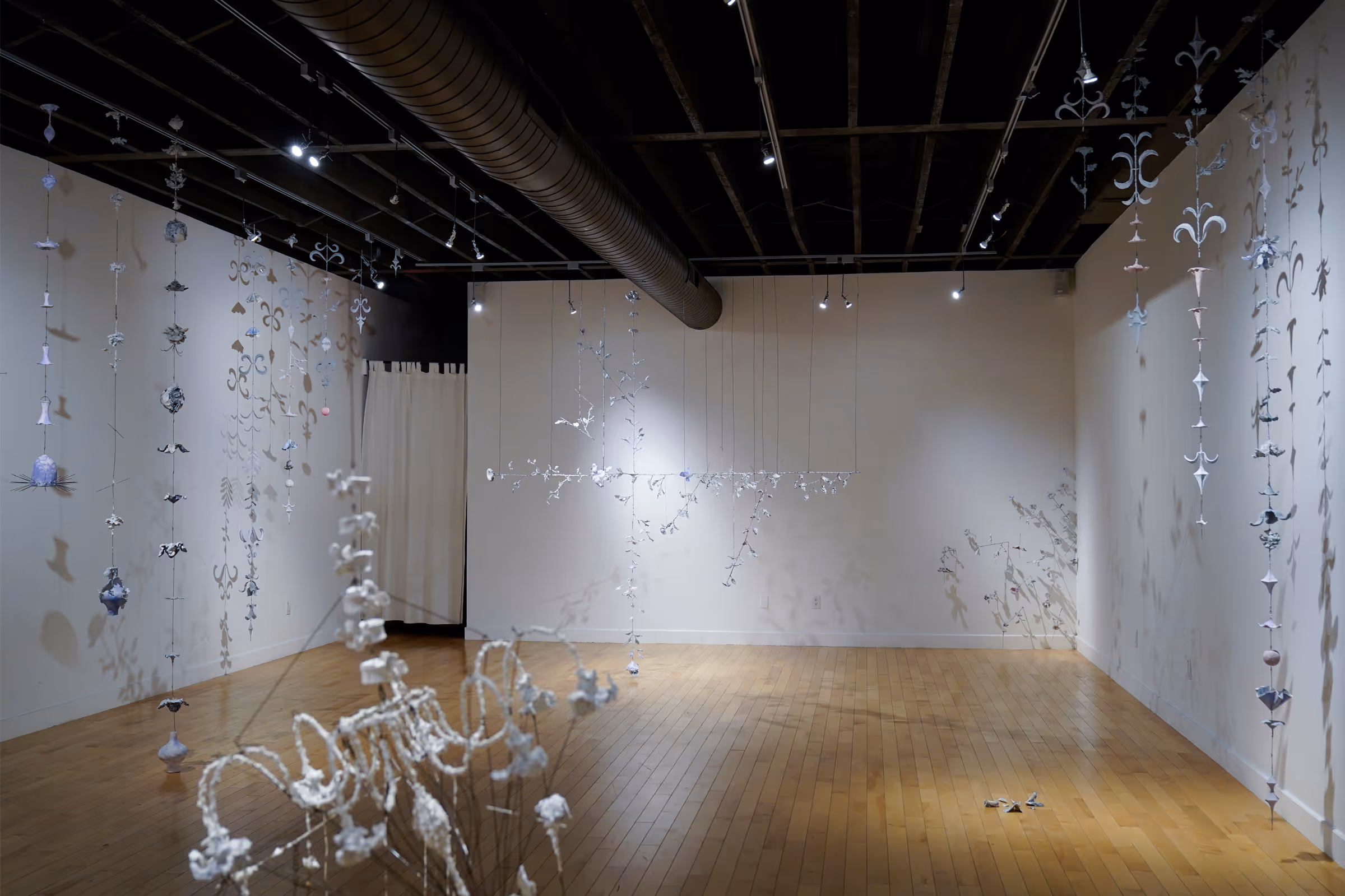 Still lives in transition (Nostalgia without memory III), 2024, Rebar tie-wire, joint compound, printer paper, ink, and inkjet transfers, 44 x 21 x 12 feet