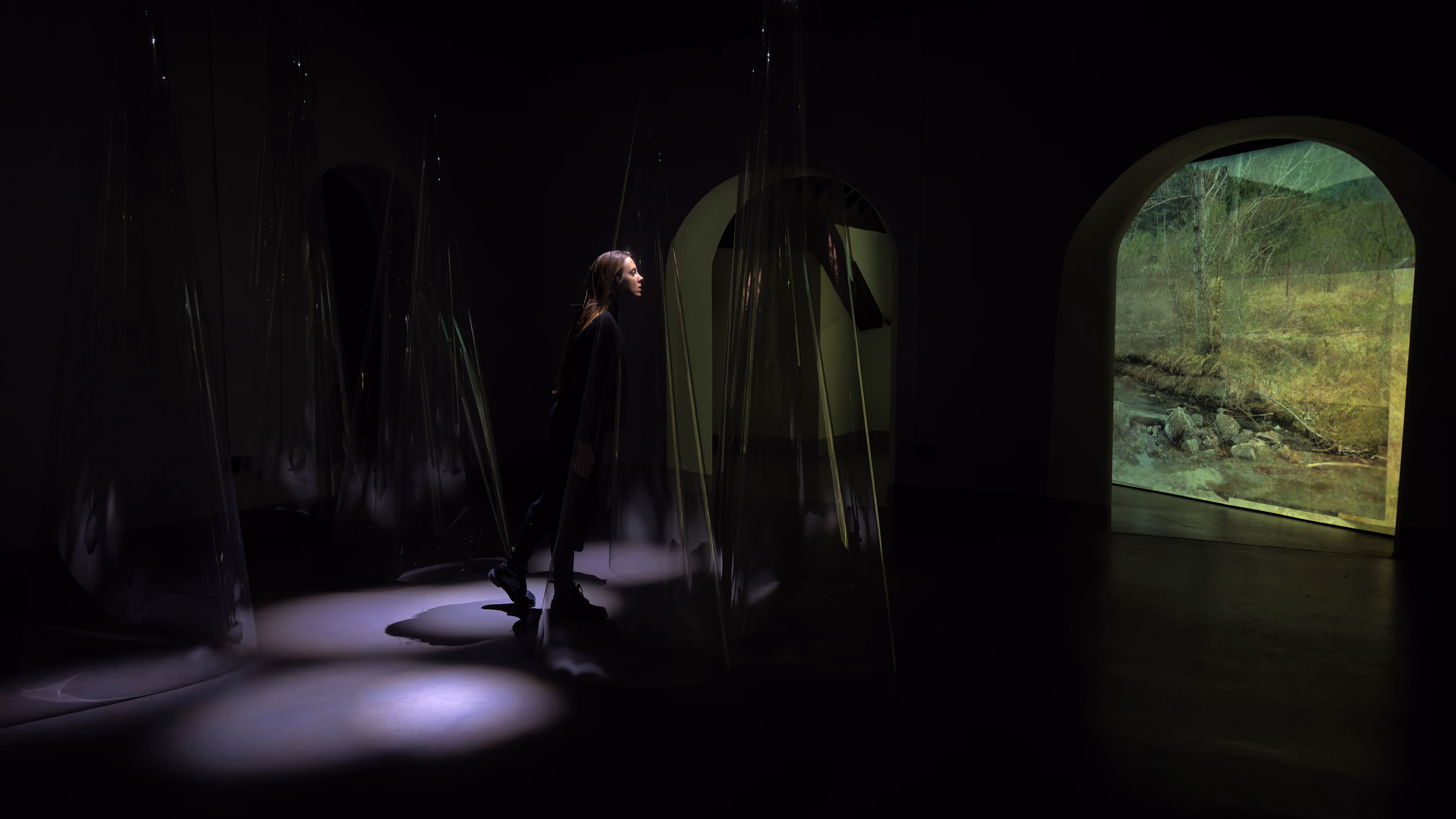 Messages of the collision. 2025.Site-specific installation.(light, polyester and original algorithm in real time, Quark - shown in a back projection). Sculpture set: 118 x 275 x 98 inches aprox. Screen: 118 x 274 inches