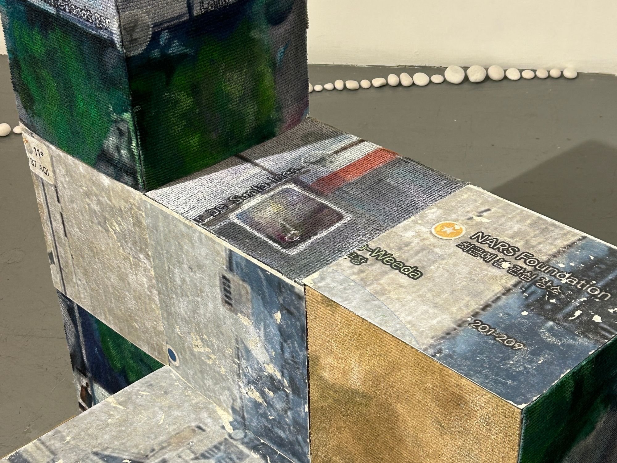 Detail of From One to Another by Jiyoung Song (2025). Image transfer on vinyl flooring, household paint, acrylic paint and oil paint on tiled carpet. Photo by Katya Borkov.