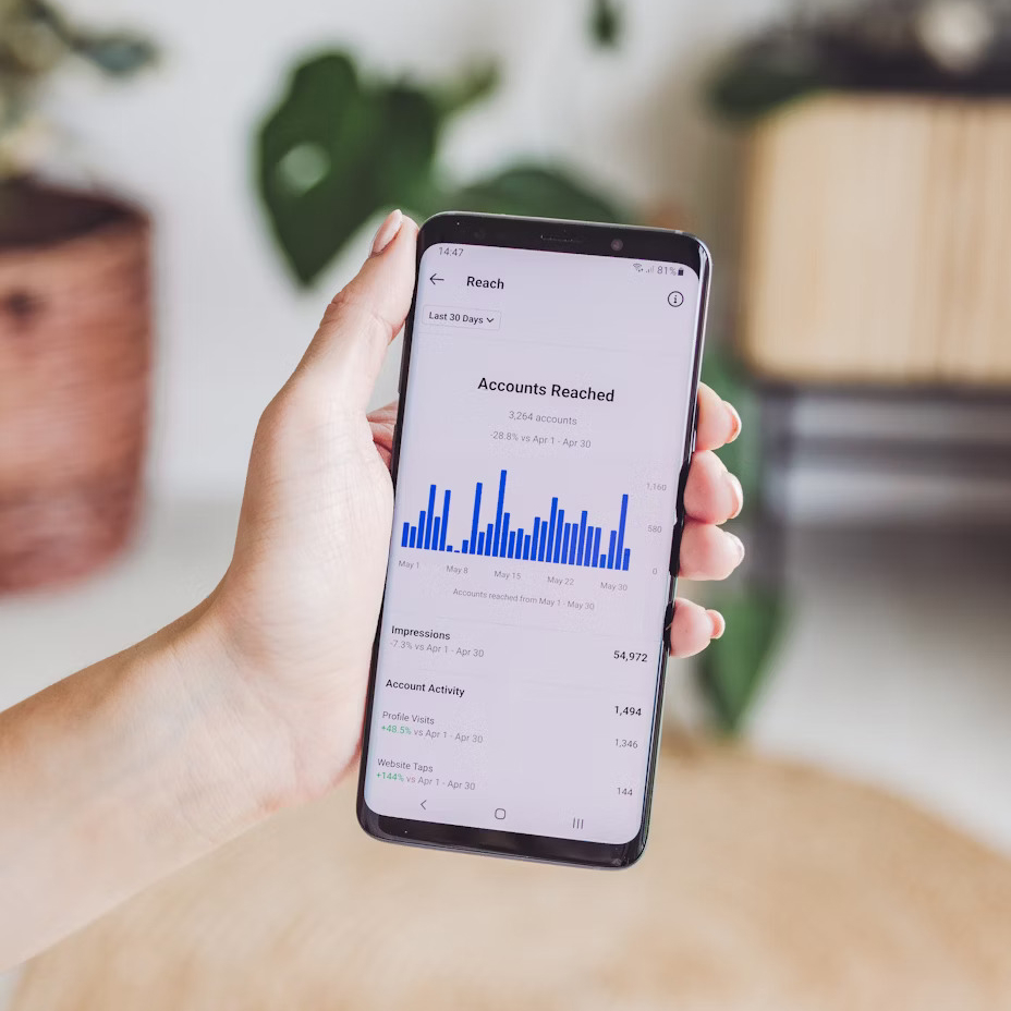 Person holding a phone with statistics