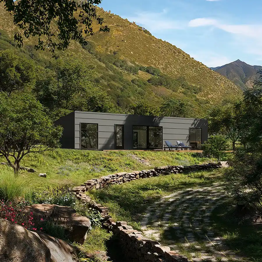 Exterior shot of a Cassette homes Jolly with a custom grey exterior in the woods.