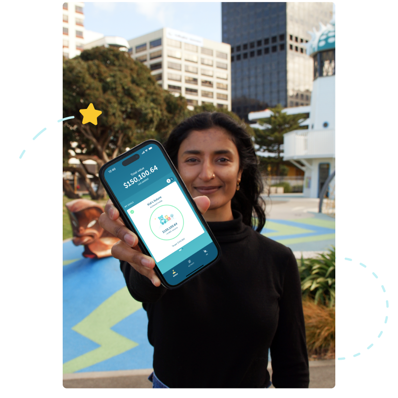 lady standing in front of a playground holding her phone