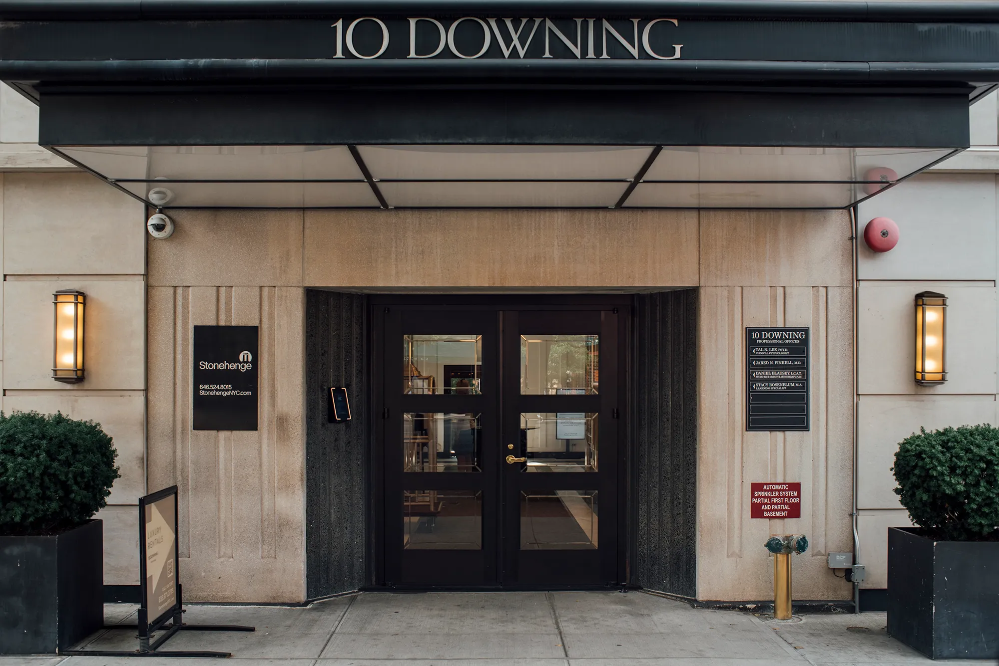 Exterior view of 10 Downing Street, the official residence of the UK Prime Minister, featuring its iconic black door.