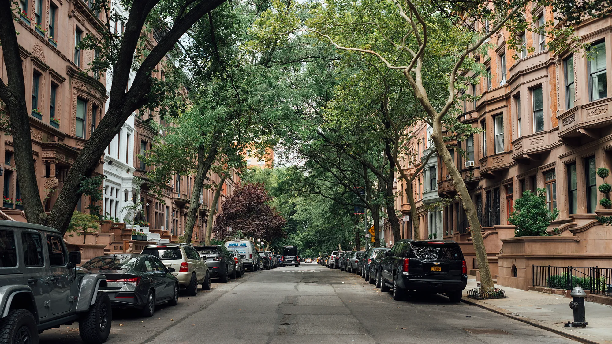 A row of tall buildings against a clear blue sky, showcasing modern architecture and urban design.