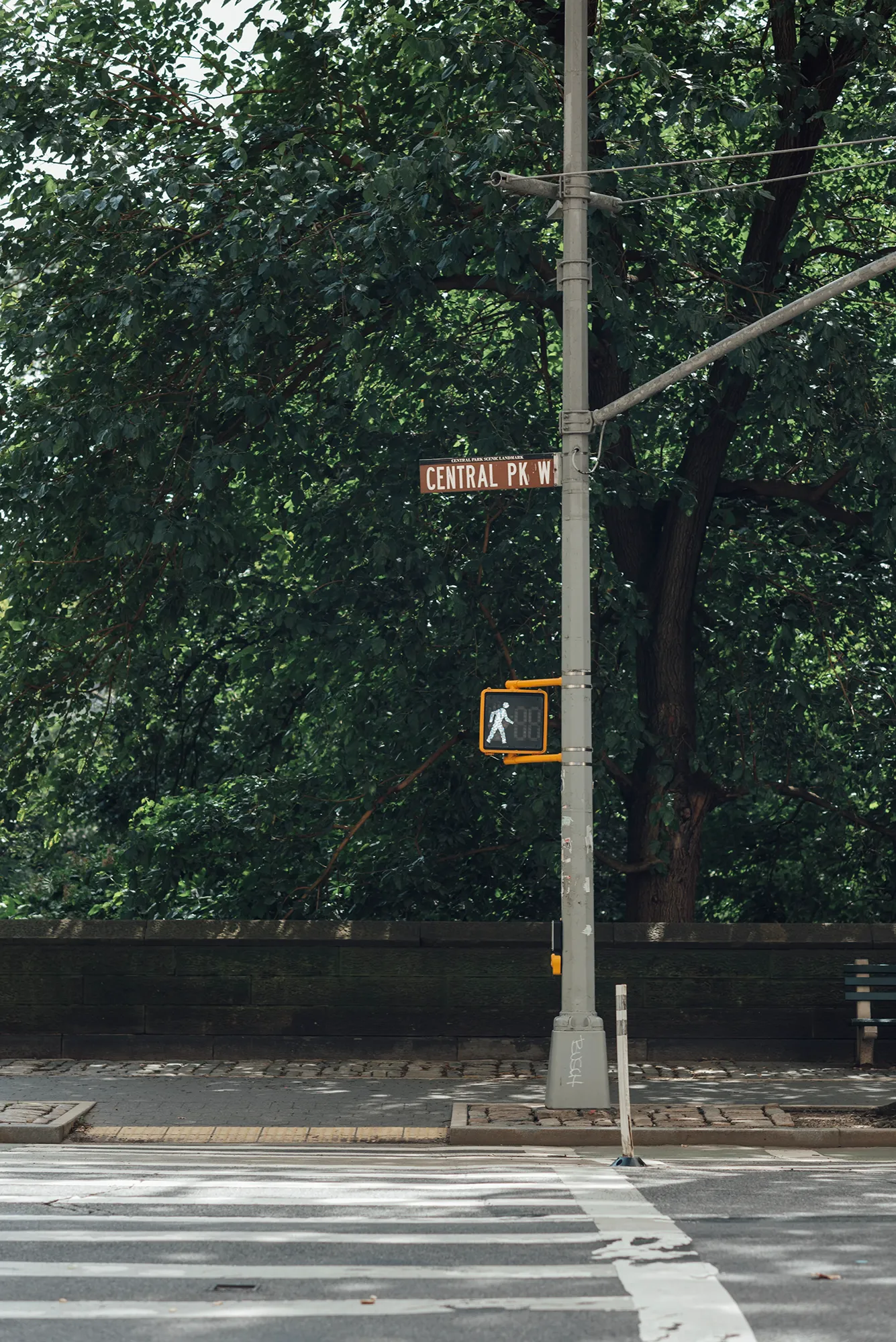 A street sign mounted on a pole, indicating directions or locations in an urban environment.