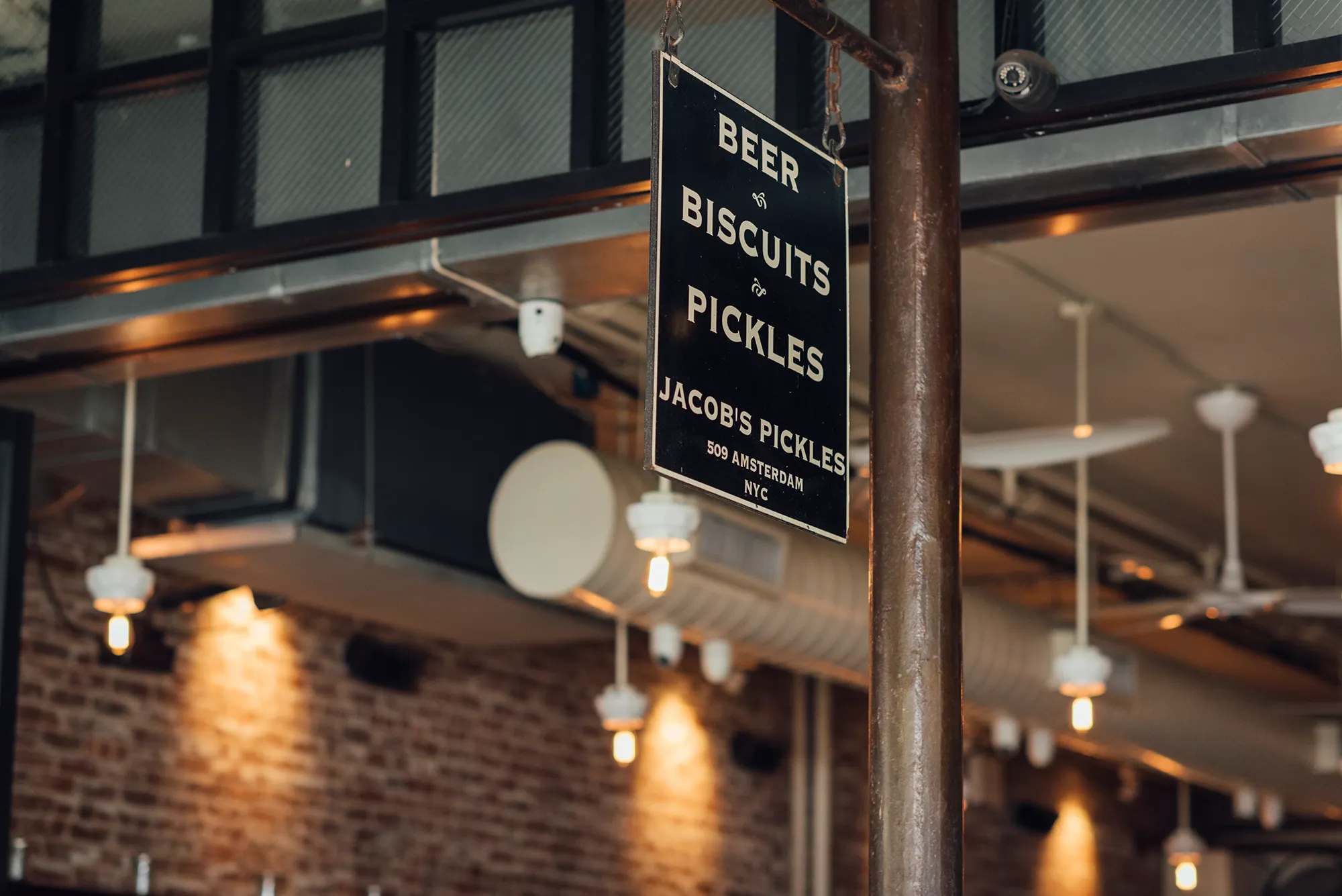 A sign displaying the text "Beer Biscuits and Pickles" in bold letters against a colorful background.