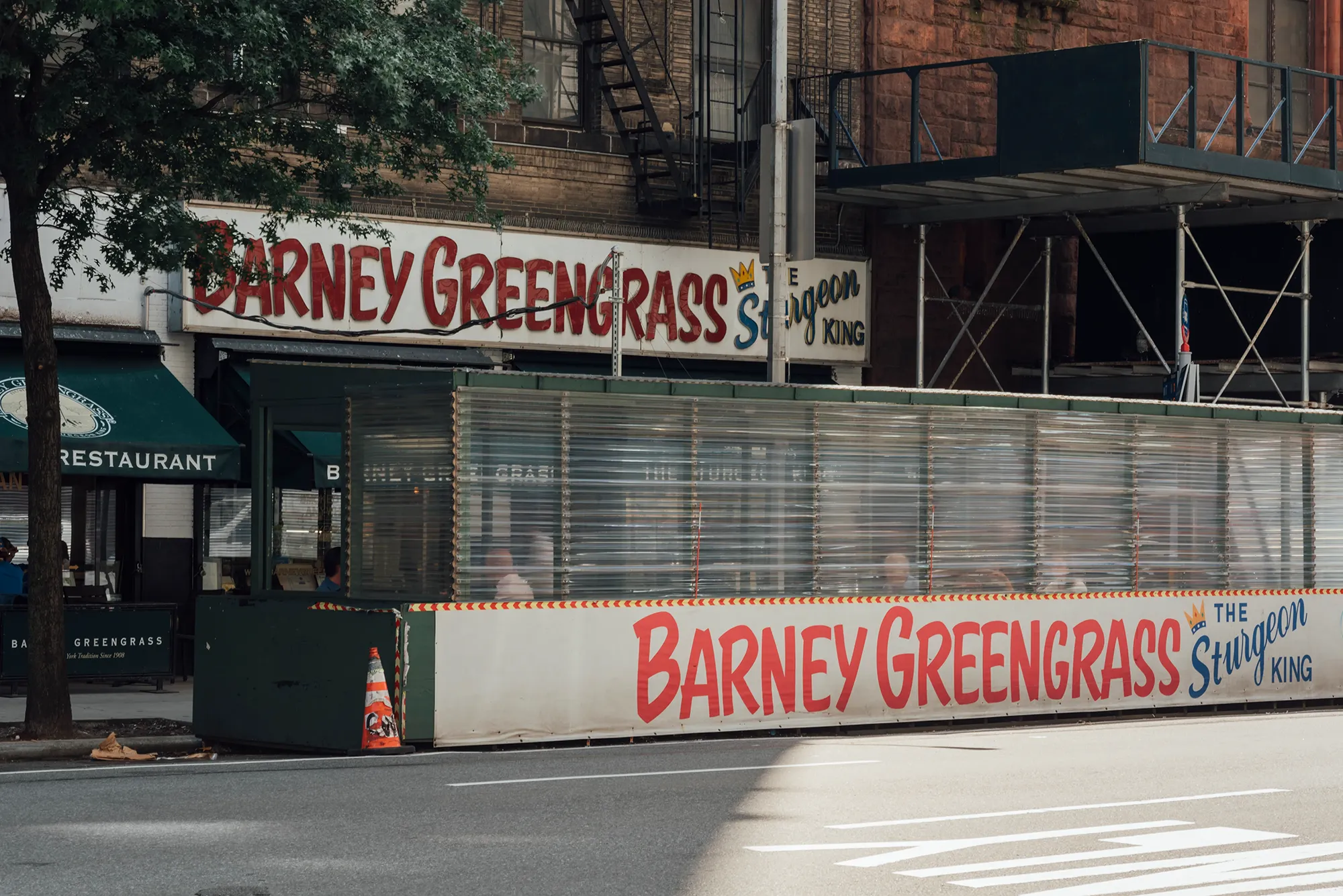 Barney Greengrass a road with buildings in the background.