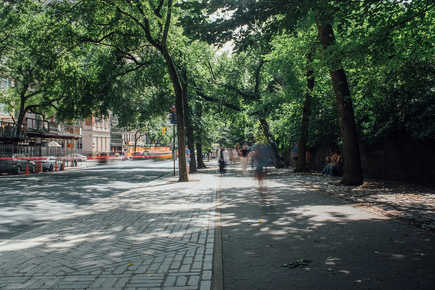 A person on a skateboard glides down a sidewalk, enjoying the outdoor activity.