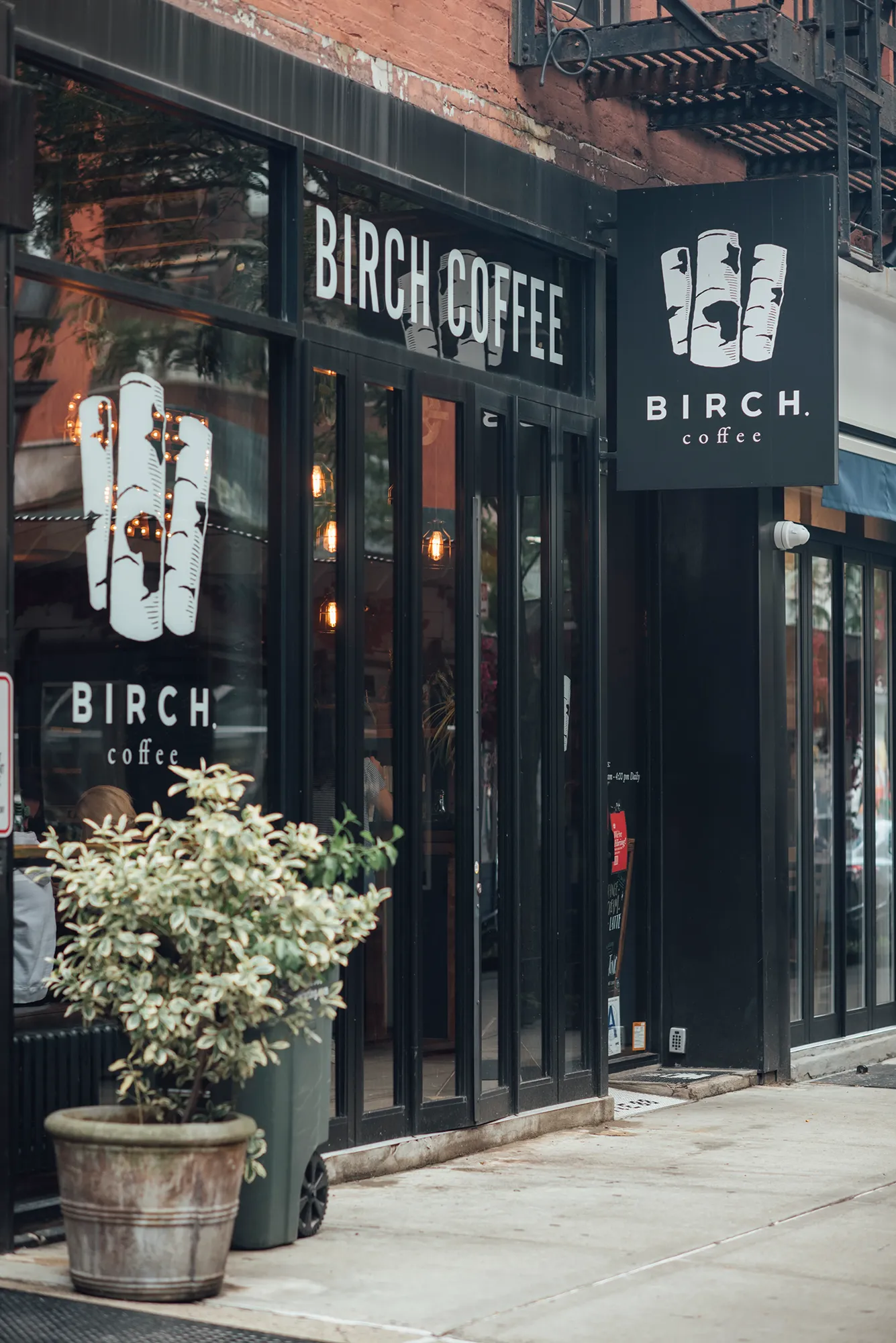 Black storefront featuring a sign that reads "Birch Coffee," indicating a coffee shop or café.