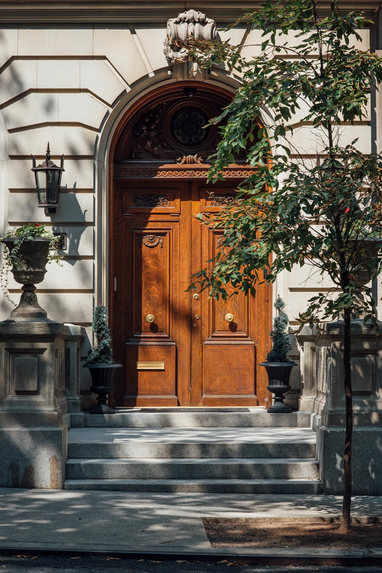 A large brown door with a smooth surface and simple design, set against a neutral background.