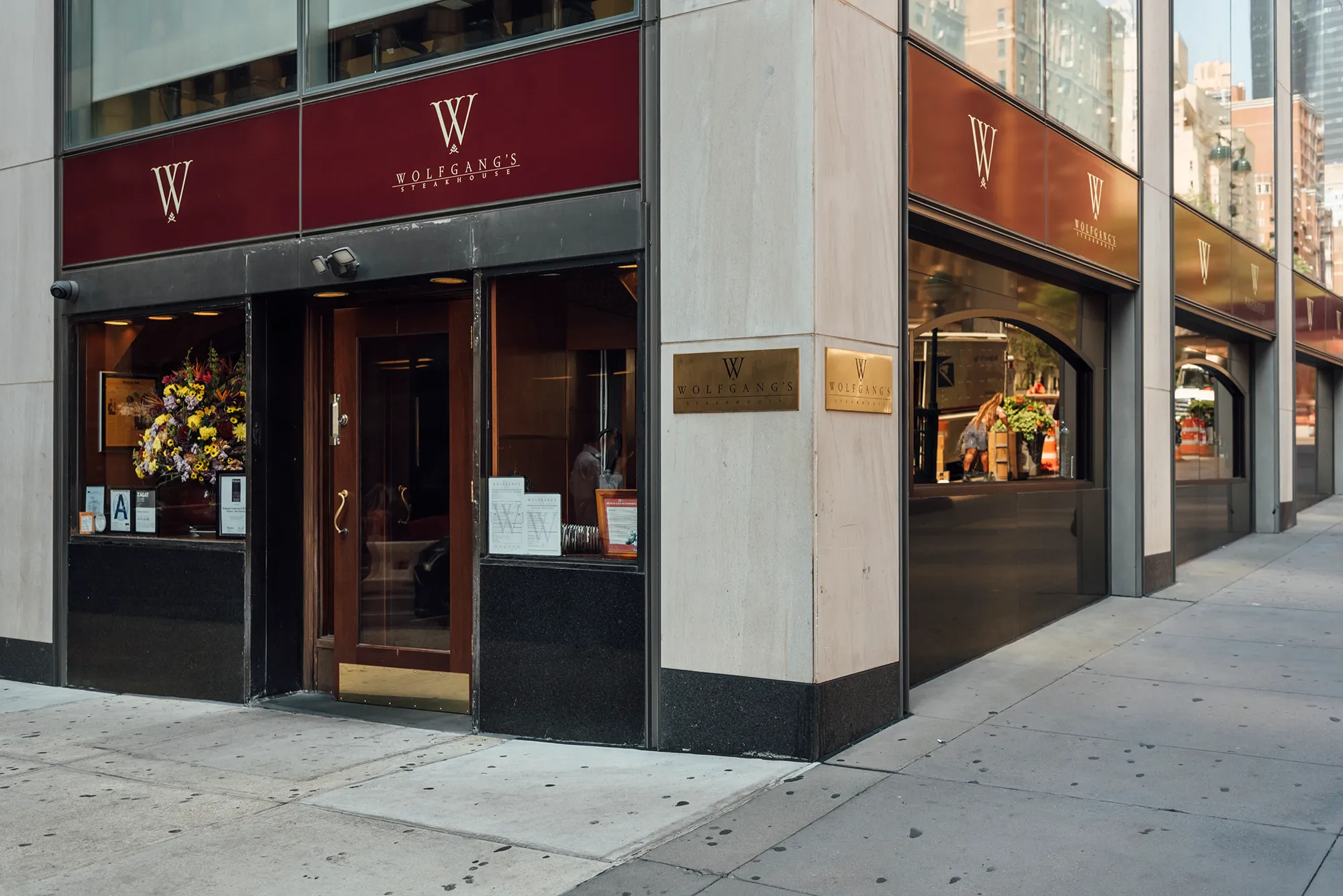 The front of a restaurant showcasing a sign with the letter "W" prominently displayed.