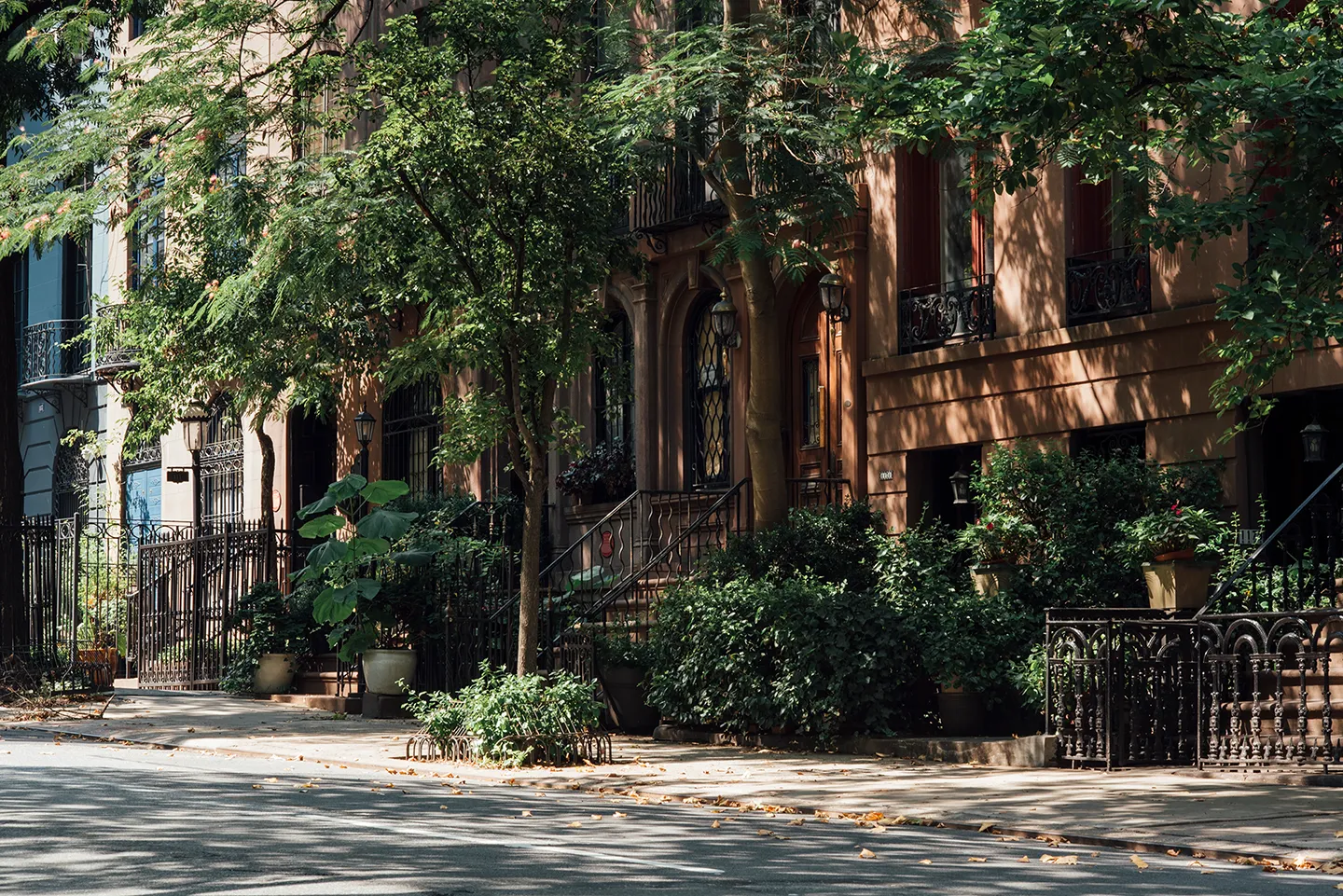 A row of tall buildings against a clear blue sky, showcasing modern architecture and urban development.