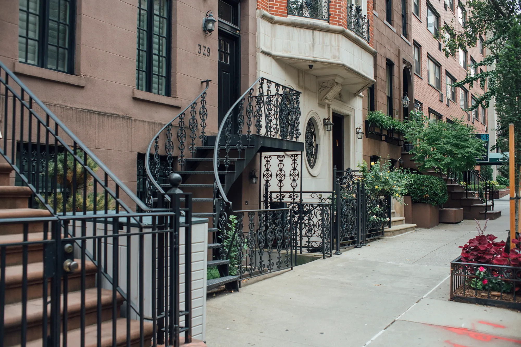 A decorative black wrought iron railing with intricate designs, providing support along a staircase.